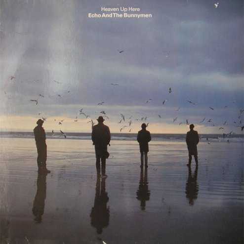 Allmusic album Review : Following their more psychedelia-based debut, Crocodiles, and subsequent "Puppet" single, Echo & the Bunnymen returned in 1981 with the darkest and perhaps most experimental album of their career. Heaven Up Here lacks the signature hooks and melodies that would make the Bunnymen famous, showcasing instead a dirge-like songwriting approach built around the circular rhythms of bassist Les Pattinson and drummer Pete DeFreitas. In this setting, the band remarkably flourishes, although they would go on to greater heights by scaling back the albums extremism. Heaven Up Heres strength is the way in which the Bunnymen seamlessly work together to shape each songs dynamics (the tension underlying the crescendo of "Turquoise Days" being a prime example). Ian McCulloch, having found his trademark confidence, sings with soaring abandon and passion throughout the album. Similarly, Will Sergeants guitar playing, notably freed from verse-chorus structure and pop riffs, is at its angular finest; his playing on "No Dark Things" is pure Andy Gill-esque skronk. The albums opening troika of "Show of Strength," "With a Hip," and "Over the Wall" (the latter with its jarring, direct invocation of Del Shannons "Runaway") are particularly effective, establishing the theme of distrust and restlessness which continues throughout the album. Indeed, even the albums lone single, "A Promise," is hardly light, pop material. But the message underneath that darkness, especially in McCullochs lyrics, is a call to overcome rather than wallow, as the album ends with the relatively euphoric "All I Want." Sitting comfortably next to the pioneering work of contemporaries like Joy Division/New Order, and early Public Image Ltd. and Cure, this is a rather fine -- and in the end, influential -- example of atmospheric post-punk. Having reached the British Top Ten, Heaven Up Here is highly regarded among Echo & the Bunnymens fans precisely for the reasons which, on the surface, make it one of the least accessible albums in the bands catalog. heaven_up_here