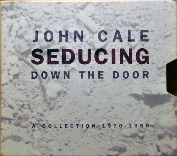 Allmusic album Review : The range of John Cales work can be shocking: its hard to believe that the piano duets with minimalist composer Terry Riley on Church of Anthrax, the lush orchestral pop of Paris 1919, and the raucous, dissonant guitar rock of "Gun" and the rest of Fear are all the work of the same man, much less that they were all released within a four-year span. The well-chosen 38-track, two-and-a-half-hour double-CD/cassette anthology Seducing Down the Door does nothing to reconcile the apparent musical contradictions in Cales classical-to-punk sensibility, but it does bring coherence and consolidation to a recording career that, spread across a multitude of labels and plagued by popular indifference, has been difficult to grasp as a whole. seducing_down_the_door_a_collection_1970_1990