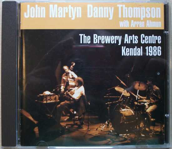Allmusic album Review : Since the early part of the 70s, John Martyn has explored various shades of folk, jazz, rock, and blues, often in tandem with double bassist Danny Thompson. This union has yielded some amazing moments both in the studio and on-stage, as is documented on such recordings as Bless the Weather, Solid Air, and Live at Leeds, to name a few. Recorded 15 years prior to its release in 2001, and nearly a decade since they had last appeared together on record, The Brewery Arts Centre Kendall 1986 is a live pairing of the two, along with drummer Arran Ahmun, in a primarily acoustic setting. Interestingly enough, a John Martyn record hadnt featured any acoustic guitar since 1977s One World, which was the last time Thompson had done a session with him. Throughout their time working together, whether on the original recordings or in concert, Martyn and Thompson have always relied on chemistry, pure musicianship, and a sort of jazz-like spontaneity, all of which are apparent on The Brewery Arts Centre. Over the course of 17 tracks, Martyn and company round up many of the usual suspects from his extensive catalog, including "Solid Air," "Bless the Weather," and "May You Never," placing them in familiar surroundings, while later tunes like "Angeline," "Lookin On," and the beautiful "Sweet Little Mystery" seem equally at home here. Thompson and Ahmun, whether setting a groove or falling in around Martyns sometimes affected, sometimes straightforward guitar, are masterful throughout. Other highlights include a conga and bass-driven "One Day Without You," the subdued passion of "Make No Mistake," and the haunting moodiness of "One World." The only real drawback, as is the case with many of these One World live recordings, is the somewhat lifeless sound. The Brewery Arts Centre may not necessarily be essential, but it should be of interest to fans. the_brewery_arts_centre_kendal_1986