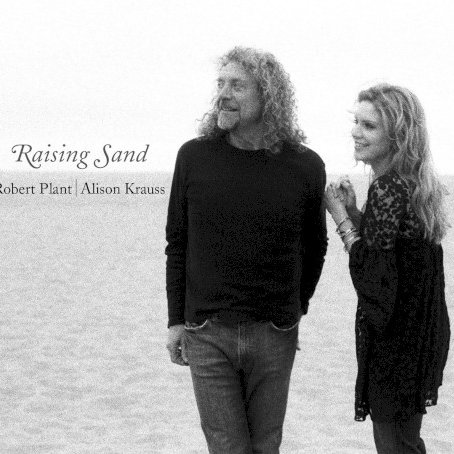 Allmusic album Review : What seems to be an unlikely pairing of former Led Zeppelin vocalist Robert Plant and bluegrass superstar Alison Krauss is actually one of the most effortless-sounding duos in modern popular music. The bridge seems to be producer T-Bone Burnett and the band assembled for this outing: drummer Jay Bellerose (who seems to be the session drummer in demand these days), upright bassist Dennis Crouch, guitarists Marc Ribot and Burnett, with Greg Leisz playing steel here and there, and a number of other guest appearances. Krauss, a monster fiddle player, only does so on two songs here. The proceedings are, predictably, very laid-back. Burnett has only known one speed these last ten years, and so the material chosen by the three is mostly very subdued. This doesnt make it boring, despite Burnetts production, which has become utterly predictable since he started working with Gillian Welch. He has a "sound" in the same way Daniel Lanois does: its edges are all rounded, everything is very warm, and it all sounds artificially dated. Sam Phillips "Sister Rosetta Goes Before Us" is a centerpiece on this set. It has her fingerprints all over it. This tune, with its forlorn, percussion-heavy tarantella backdrop, might have come from a Tom Waits record were it not so intricately melodic -- and Krauss gypsy swing fiddle is a gorgeous touch. There is an emptiness at the heart of longing particularly suited to Krauss woodsy voice, and Plants harmony vocal is perfect, understated yet ever-present. Its the most organically atmospheric tune on the set -- not in terms of production, but for lyric and compositional content. Stellar.<br><br> Plants own obsession with old rockabilly and blues tunes is satisfied on the sets opener, "Rich Woman," by Dorothy LaBostrie and McKinley Miller. Its all swamp, all past midnight, all gigolo boasting. Krauss harmony vocal underscores Plants low-key crooned boast as a mirror, as the person being used and who cant help it. Rollie Salleys "Killing the Blues" is all cough syrup guitars, muffled tom toms, and played-in-bedroom atmospherics. Nonetheless, the two vocalists make a brilliant song come to life with their shared sorrow, and its as if the meaning in the tune actually happens from the bitter irony in the space between the two vocalists as the whine of Leiszs steel roots this country song in the earth, not in the white clouds reflected in its refrain. There are a pair of Gene Clark tunes here as well. Plant is a Clark fan, and so its not a surprise, but the choices are: "Polly Come Home" and "Through the Morning, Through the Night" come from the second Dillard & Clark album from 1969 with the same title as the latter track. The first is a haunting ballad done in an old-world folk style that Clark would have been proud of. It reflects the same spirit and character as his own White Light album, but with Plant and Krauss, the spirit of Celtic-cum-Appalachian style that influenced bluegrass, and the Delta blues that influenced rock, are breached. "Through the Morning, Through the Night" is a wasted country love song told from the point of view of an outlaw. Plant gets his chance to rock -- a bit -- in the Everly Brothers "Gone Gone Gone (Done Moved On)." While it sounds nothing like the original, Plants pipes get to croon and drift over the distorted guitars and a clipped snare; he gets to do his trademark blues improv bit between verses. To be honest, it feels like it was tossed off and, therefore, less studied than anything else here: its a refreshing change of pace near the middle of the disc. It "rocks" in a roots way.<br><br> "Please Read the Letter" is written by Plant, Page Charlie Jones, and Michael Lee. Slow, plodding, almost crawling, Krauss harmony vocal takes it to the next step, adds the kind of lonesome depth that makes this a song whispered under a starless sky rather than just another lost love song. Waits and Kathleen Brennans "Trampled Rose," done shotgun ballad style, is, with the Phillips tune, the most beautiful thing here. Krauss near the top of her range sighs into the rhythm. Patrick Warrens toy piano sounds more like a marimba, and his pump organ adds to the percussive nature of this wary hymn from the depths. When she sings "You never pay just once/To get the job done," this skeletal band swells. Ribots dobro sounds like a rickety banjo, and it stutters just ahead of the bass drum and tom toms in Belleroses kit. Naomi Nevilles "Fortune Teller" shows Burnett at his best as a producer. He lets Plants voice come falling out of his mouth, staggering and stuttering the rhythms so they feel like a combination of Delta blues, second-line New Orleans, and Congo Square drum walk. The guitar is nasty and distorted, and the brush touches with their metallic sheen are a nice complement to the bass drums. It doesnt rock; it struts and staggers on its way. Krauss wordless vocal in the background creates a nice space for that incessant series of rhythms to play to.<br><br> The next three tunes are cagey, even for this eclectic set: Mel Tillis awesome ballad "Stick with Me Baby" sounds more like Dion & the Belmonts on the street corner on cough syrup and meaning every word. There is no doo wop, just the sweet melody falling from the singers mouths like an incantation with an understated but pronounced rhythm section painting them singing together in front of a burning ash can. This little gem is followed by a reading of Townes Van Zandts "Nothin" done in twilight Led Zeppelin style. It doesnt rock either. It plods and drifts, and crawls. Krauss fiddle moans above the tambourine, indistinct and distorted; low-tuned electric guitars and the haunted, echoing banjo are a compelling move and rescue the melody from the sonic clutter -- no, sonic clutter is not a bad thing. The weirdest thing is that while its the loudest tune on the set, it features Norman Blake on acoustic guitar with Burnett. This is what singer/songwriter heavy metal must sound like. And it is oh-so-slow. The final part of the trilogy of the weird takes place on Little Milton Campbells "Let Your Loss Be Your Lesson," a jangly country rocker in the vein of Neil Young without the weight and creak of age hindering it. Krauss is such a fine singer, and she does her own Plant imitation here. She has his phrasing down, his slippery way of enunciating, and you can hear why this was such a great match-up. The band can play backbone slip rockabilly shuffle with their eyes closed and their hands tied behind their backs, and they do it here. Its a great moment before the close. The haunting, old-timey "Your Long Journey by A.D. and Rosa Lee Watson," with its autoharp (played by Mike Seeger no less), Riley Baugus banjo, Crouchs big wooden bass, and Blakes acoustic guitar, is a whispering way to send this set of broken love songs off into the night. These two voices meld together seamlessly; they will not be swallowed even when the production is bigger than the song. They dont soar, they dont roar, they simply sing songs that offer different shades of meaning as a result of this welcome collaboration. raising_sand